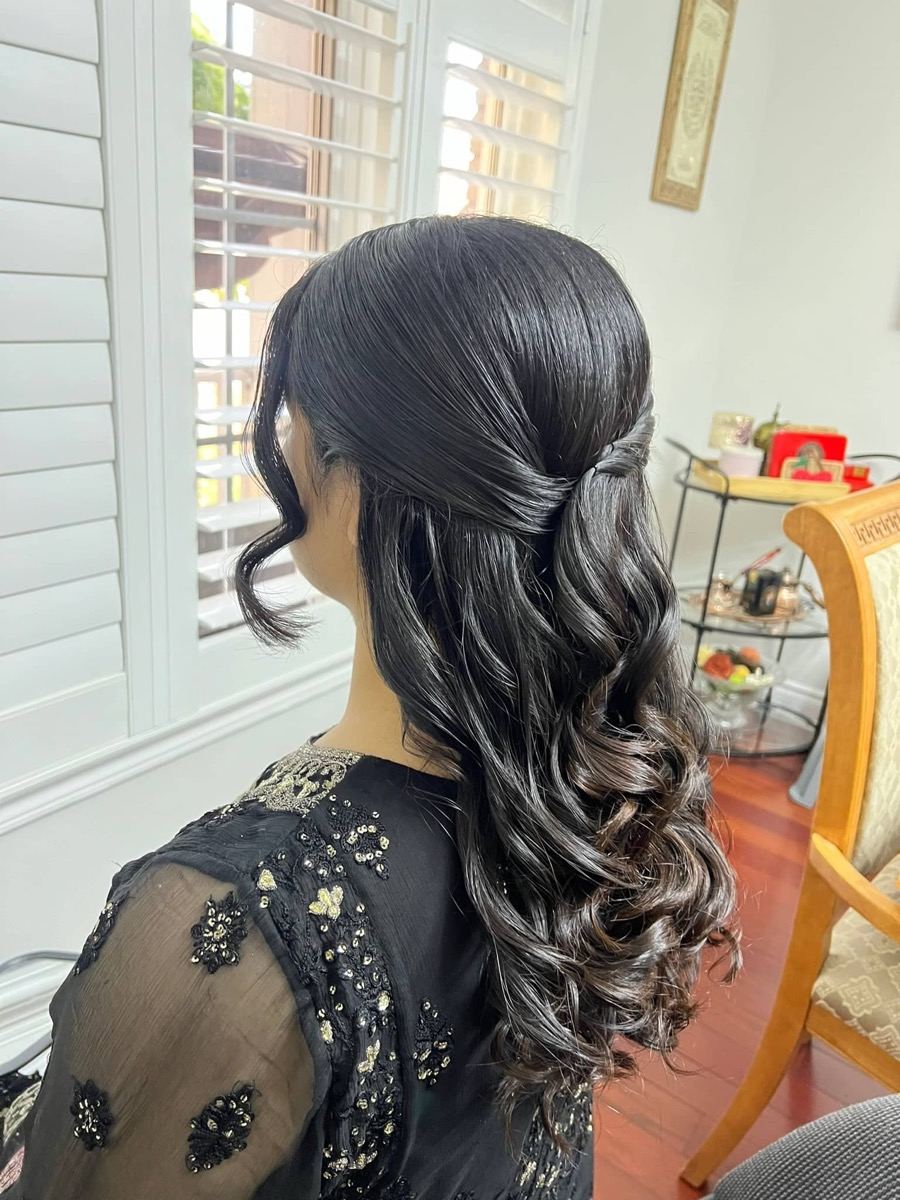 Glossy half-up hairstyle by Simran Khurana