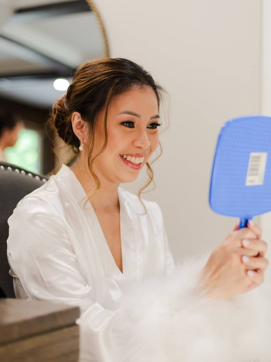 Bride smiling after makeup application